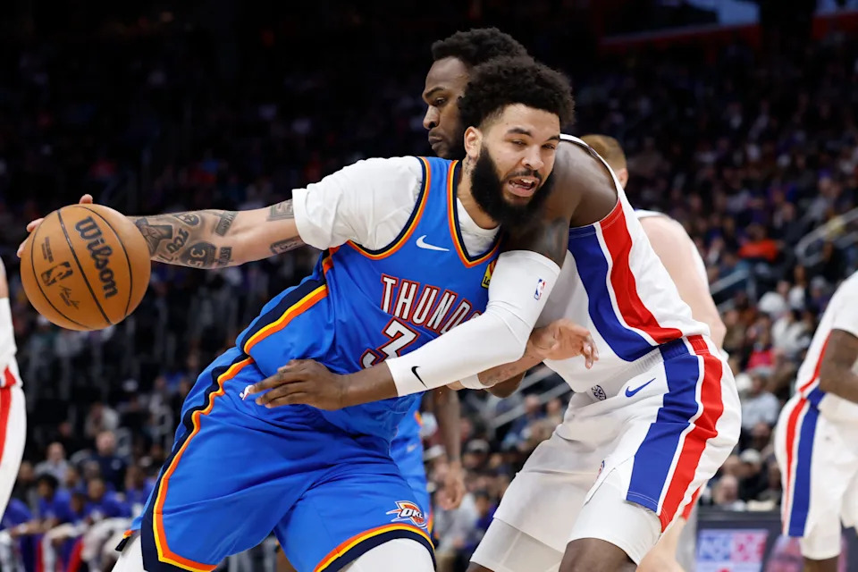 Feb 25, 2026; Detroit, Michigan, USA; Oklahoma City Thunder guard Kenrich Williams (34) is defended by Detroit Pistons forward Paul Reed (7) in the second half at Little Caesars Arena. Mandatory Credit: Rick Osentoski-Imagn Images