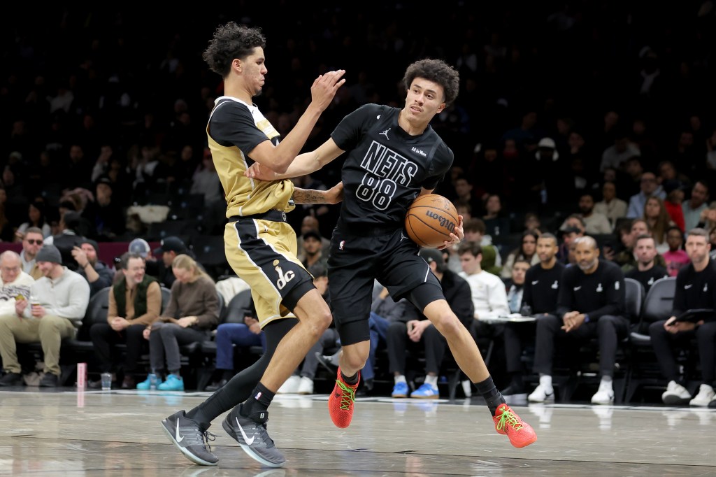 Brooklyn Nets guard Nolan Traore (88) drives to the basket against Washington Wizards guard Will Riley (27).
