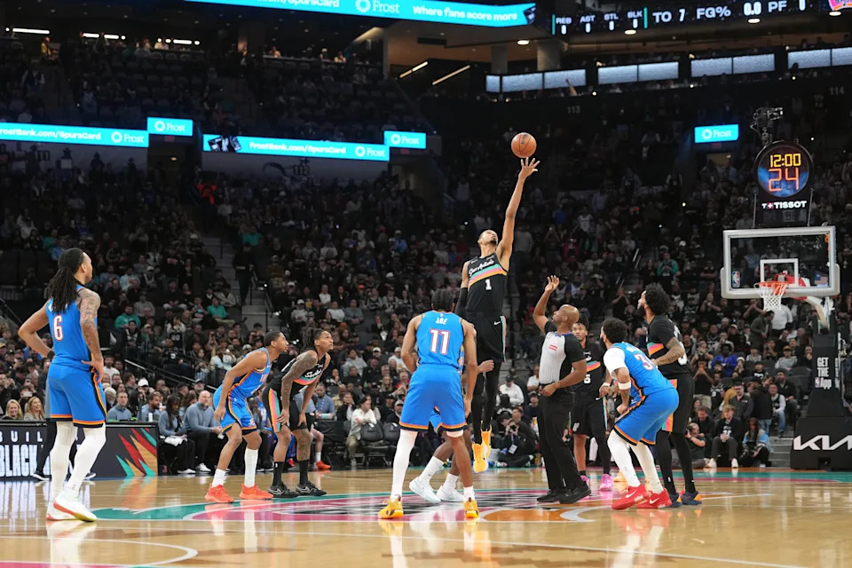 Feb 4, 2026; San Antonio, Texas, USA; San Antonio Spurs forward Victor Wembanyama (1) going for a jump ball to start a game against the Oklahoma City Thunder at Frost Bank Center. Mandatory Credit: Scott Wachter-Imagn Images