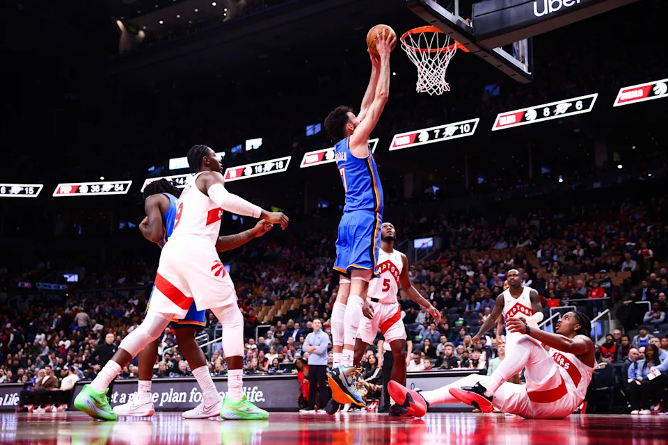 TORONTO, CANADA - FEBRUARY 24: Chet Holmgren #7 of the Oklahoma City Thunder dunks as Collin Murray-Boyles #12 of the Toronto Raptors looks up from the floor during the second half of their NBA game at Scotiabank Arena on February 24, 2026 in Toronto, Ontario, Canada. NOTE TO USER: User expressly acknowledges and agrees that, by downloading and or using this photograph, User is consenting to the terms and conditions of the Getty Images License Agreement. (Photo by Cole Burston/Getty Images)