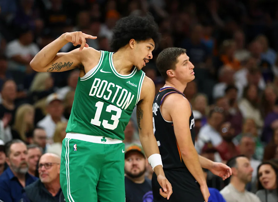 Feb 24, 2026; Phoenix, Arizona, USA; Boston Celtics guard Ron Harper Jr. (13) celebrates a three point shot alongside Phoenix Suns guard Collin Gillespie in the second half at Mortgage Matchup Center. Mandatory Credit: Mark J. Rebilas-Imagn Images