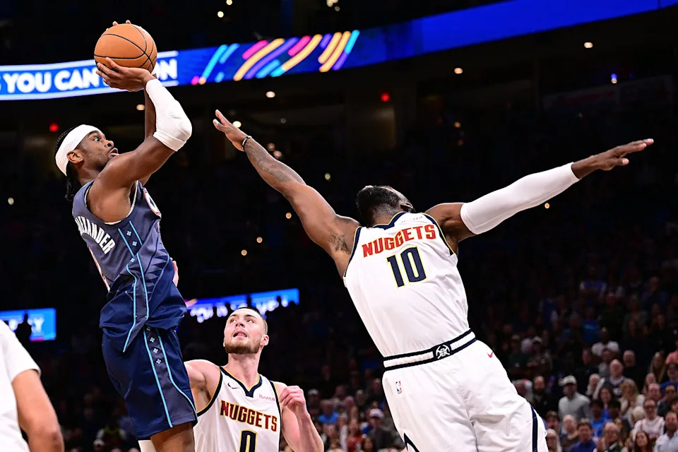 OKLAHOMA CITY, OKLAHOMA - FEBRUARY 27: Shai Gilgeous-Alexander #2 of the Oklahoma City Thunder attempts a shot in front of Tim Hardaway Jr. #10 of the Denver Nuggets during the second half at Paycom Center on February 27, 2026 in Oklahoma City, Oklahoma. NOTE TO USER: User expressly acknowledges and agrees that, by downloading and or using this photograph, User is consenting to the terms and conditions of the Getty Images License Agreement. (Photo by Joshua Gateley/Getty Images)