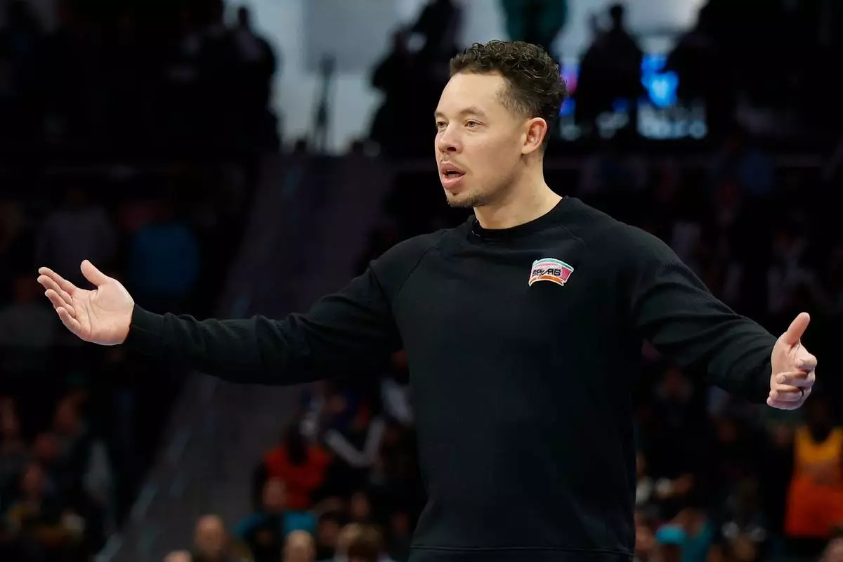 San Antonio Spurs head coach Mitch Johnson reacts to a call during the second half of an NBA basketball game against the Charlotte Hornets in Charlotte, N.C., Saturday, Jan. 31, 2026. (AP Photo/Nell Redmond)