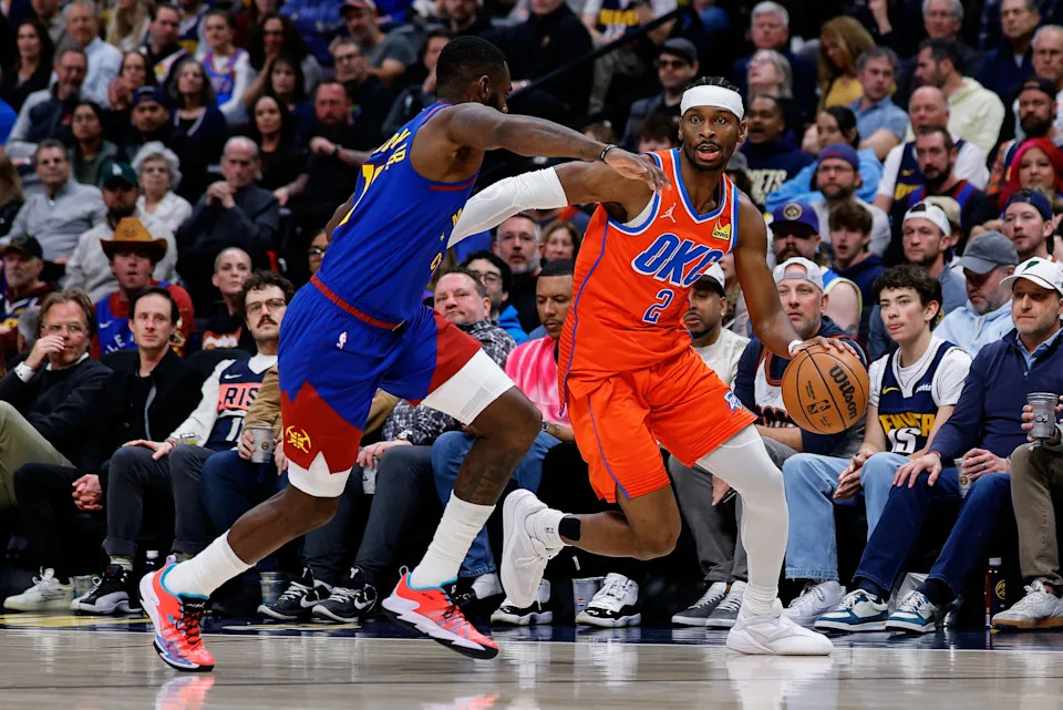 Feb 1, 2026; Denver, Colorado, USA; Oklahoma City Thunder guard Shai Gilgeous-Alexander (2) controls the ball as Denver Nuggets guard Tim Hardaway Jr. (10) guards in the second quarter at Ball Arena. Mandatory Credit: Isaiah J. Downing-Imagn Images