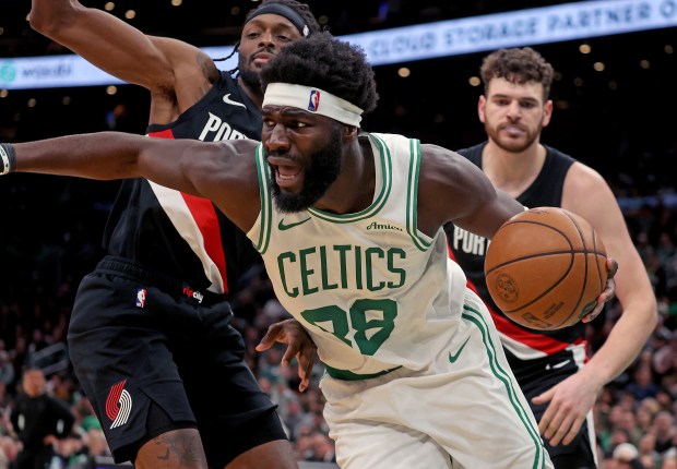 Boston Celtics center Neemias Queta (88) gets around Portland Trail Blazers forward Jerami Grant (9) and center Donovan Clingan (23) during the second half of a NBA game at TD Garden. (Photo By Matt Stone/Boston Herald).