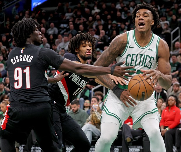 Portland Trail Blazers guard Sidy Cissoko (91) and guard Shaedon Sharpe (17) double team Boston Celtics forward Amari Williams (77) during the second half of a NBA game at the Garden. (Photo By Matt Stone/Boston Herald).