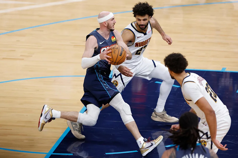 Feb 27, 2026; Oklahoma City, Oklahoma, USA; Oklahoma City Thunder guard Alex Caruso (9) drives to the basket between Denver Nuggets guard Jamal Murray (27) and forward Cameron Johnson (23) during the fourth quarter at Paycom Center. Mandatory Credit: Alonzo Adams-Imagn Images