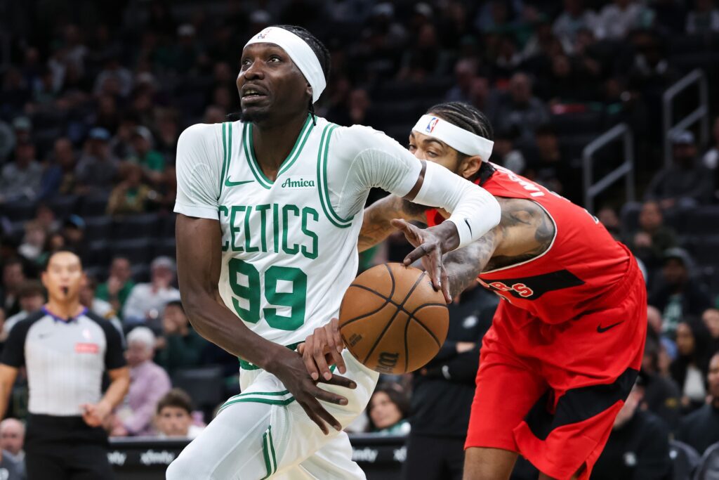Oct 15, 2025; Boston, Massachusetts, USA; Toronto Raptors forward Brandon Ingram (3) knocks the ball away from Boston Celtics center Chris Boucher (99) during the first half at TD Garden. Mandatory Credit: Paul Rutherford-Imagn Images
