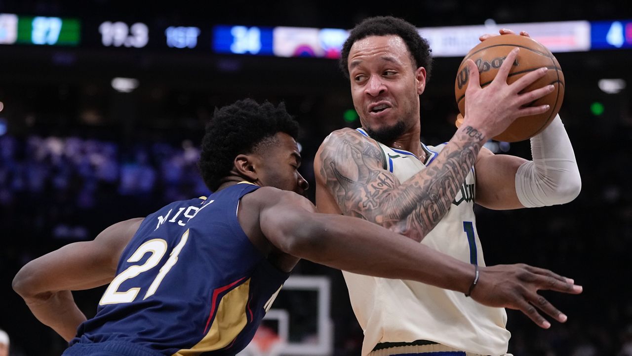 Milwaukee Bucks' Amir Coffey tries to get past New Orleans Pelicans' Yves Missi during the first half of an NBA basketball game Wednesday, Feb. 4, 2026, in Milwaukee.