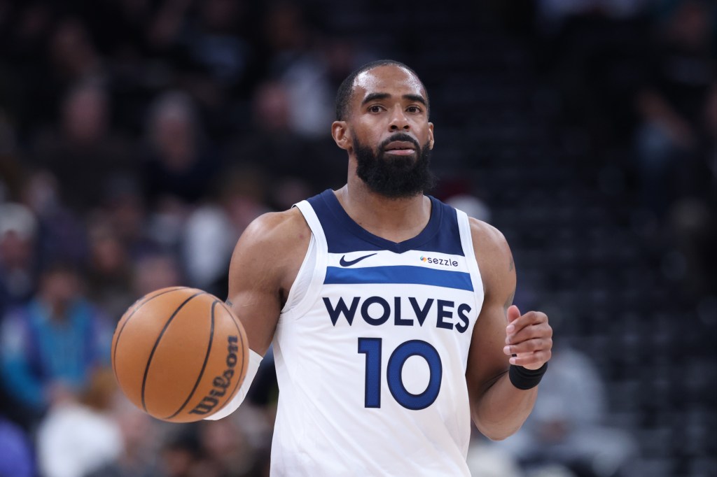 Minnesota Timberwolves guard Mike Conley (10) bring the ball up the court against the Utah Jazz during the second half at Delta Center.