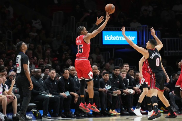 Chicago Bulls forward Isaac Okoro (35) shoots as Miami Heat forward Simone Fontecchio (0) defends during the first half of an NBA basketball game, Sunday, Feb. 1, 2026, in Miami. (AP Photo/Lynne Sladky)