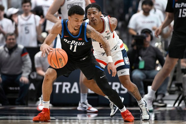 DePaul Blue guard CJ Gunn (11) is guarded by UConn guard Silas Demary Jr. in the second half of an NCAA college basketball game, Saturday, Jan. 10, 2026, in Hartford, Conn. (AP Photo/Jessica Hill)