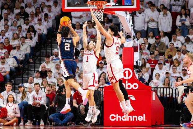 Illinois guard Andrej Stojakovic goes up to shoot against Nebraska guard Sam Hoiberg and forward Berke Büyüktuncel on Sunday, Feb. 1, 2026, in Lincoln, Neb. (AP Photo/Bonnie Ryan)