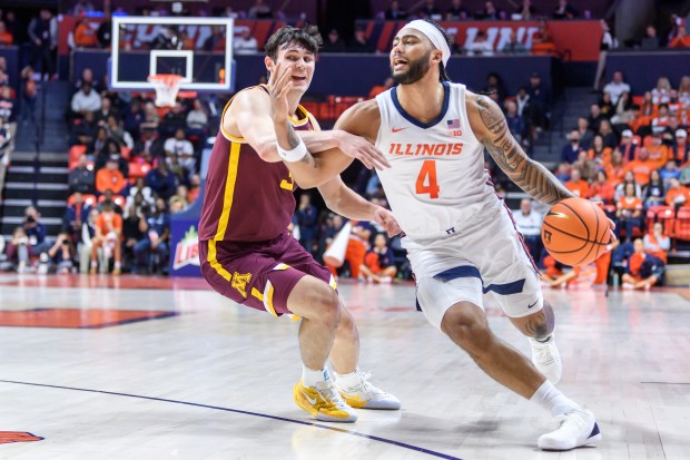 Illinois guard Kylan Boswell drives against defensive pressure from Minnesota's Bobby Durkin on Saturday, Jan. 17, 2026, in Champaign, Ill. (AP Photo/Craig Pessman)