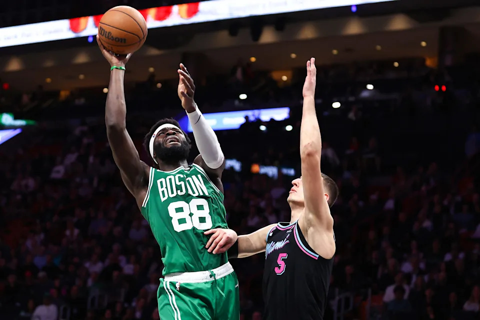 MIAMI, FLORIDA - JANUARY 15: Neemias Queta #88 of the Boston Celtics goes to the basket against Nikola Jovic #5 of the Miami Heat during the second quarter of the game at Kaseya Center on January 15, 2026 in Miami, Florida. NOTE TO USER: User expressly acknowledges and agrees that, by downloading and or using this photograph, User is consenting to the terms and conditions of the Getty Images License Agreement (Photo by Megan Briggs/Getty Images)