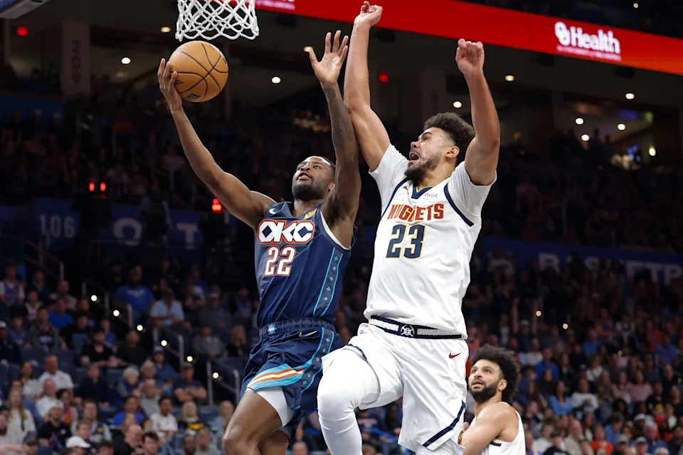 Feb 27, 2026; Oklahoma City, Oklahoma, USA; Oklahoma City Thunder guard Cason Wallace (22) goes up for a basket beside Denver Nuggets forward Cameron Johnson (23) during the third quarter at Paycom Center. Mandatory Credit: Alonzo Adams-Imagn Images