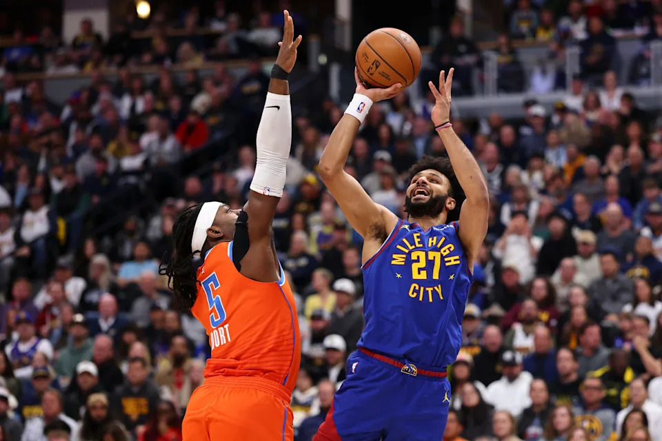 DENVER, COLORADO - FEBRUARY 01: Jamal Murray #27 of the Denver Nuggets shoots the ball over Luguentz Dort #5 of the Oklahoma City Thunder during the first quarter at Ball Arena on February 1, 2026 in Denver, Colorado. NOTE TO USER: User expressly acknowledges and agrees that, by downloading and or using this photograph, User is consenting to the terms and conditions of the Getty Images License Agreement. (Photo by Justin Tafoya/Getty Images)