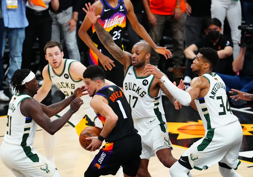 Phoenix Suns' Devin Booker tries to escape Milwaukee Bucks defense in 2021 NBA FinalsMark J&period; Rebilas-Imagn Images