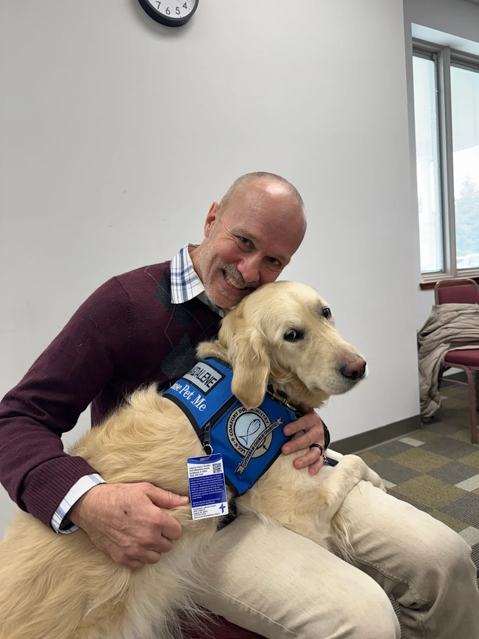 IndyStar columnist Gregg Doyel (left) with Magdalane, a comfort dog at Cornerstone Lutheran Church