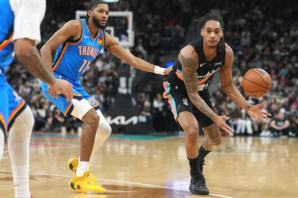 Feb 4, 2026; San Antonio, Texas, USA; San Antonio Spurs guard Devin Vassell (24) passes the ball while defended by guard Isaiah Joe (11) of the Oklahoma City Thunder during the first half at Frost Bank Center. Mandatory Credit: Scott Wachter-Imagn Images