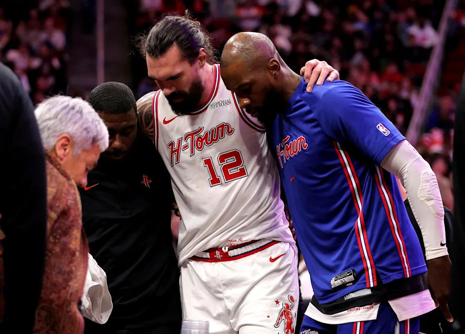Jan 18, 2026; Houston, Texas, USA; Houston Rockets center Steven Adams (12) is helped off the court after an injury against the New Orleans Pelicans during the fourth quarter at Toyota Center. Mandatory Credit: Erik Williams-Imagn Images
