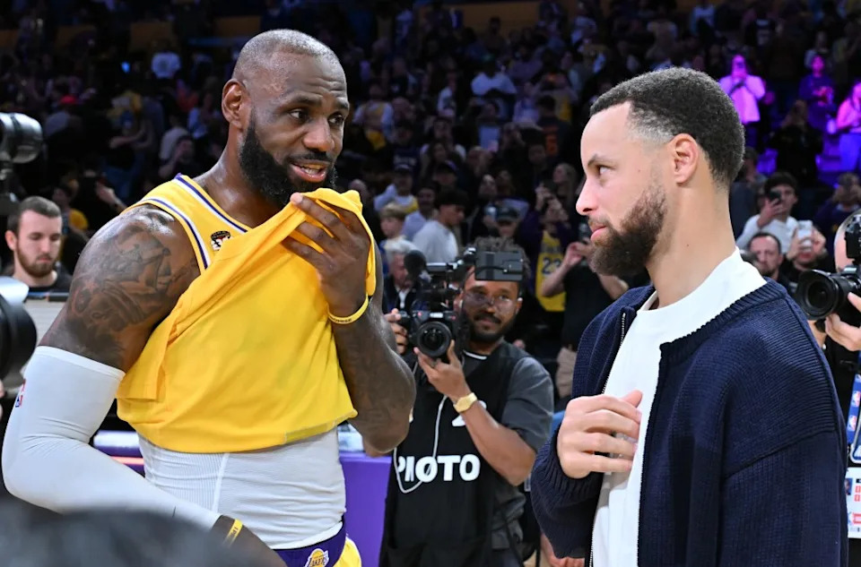 LeBron James speaks with Stephen Curry following a basketball game between the Los Angeles Lakers and the Golden State Warriors at Crypto.com Arena on February 07, 2026. (Photo by Allen Berezovsky/Getty Images) Getty Images