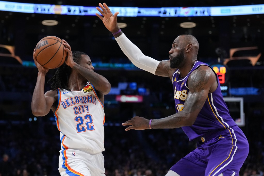 LeBron James (23) defends Cason Wallace (22) during an NBA game.
