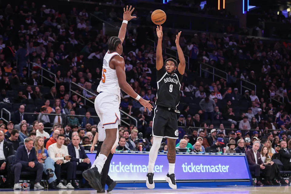 Nov 9, 2025; New York, New York, USA; Brooklyn Nets forward E.J. Liddell (9) takes a three point shot past New York Knicks center Ariel Hukporti (55) in the fourth quarter at Madison Square Garden. Mandatory Credit: Wendell Cruz-Imagn Images