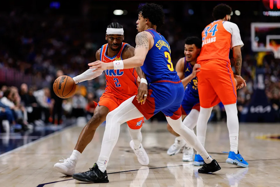 Feb 1, 2026; Denver, Colorado, USA; Oklahoma City Thunder guard Shai Gilgeous-Alexander (2) controls the ball against Denver Nuggets guard Julian Strawther (3) as guard Kenrich Williams (34) defends against forward Spencer Jones (21) in the second quarter at Ball Arena. Mandatory Credit: Isaiah J. Downing-Imagn Images
