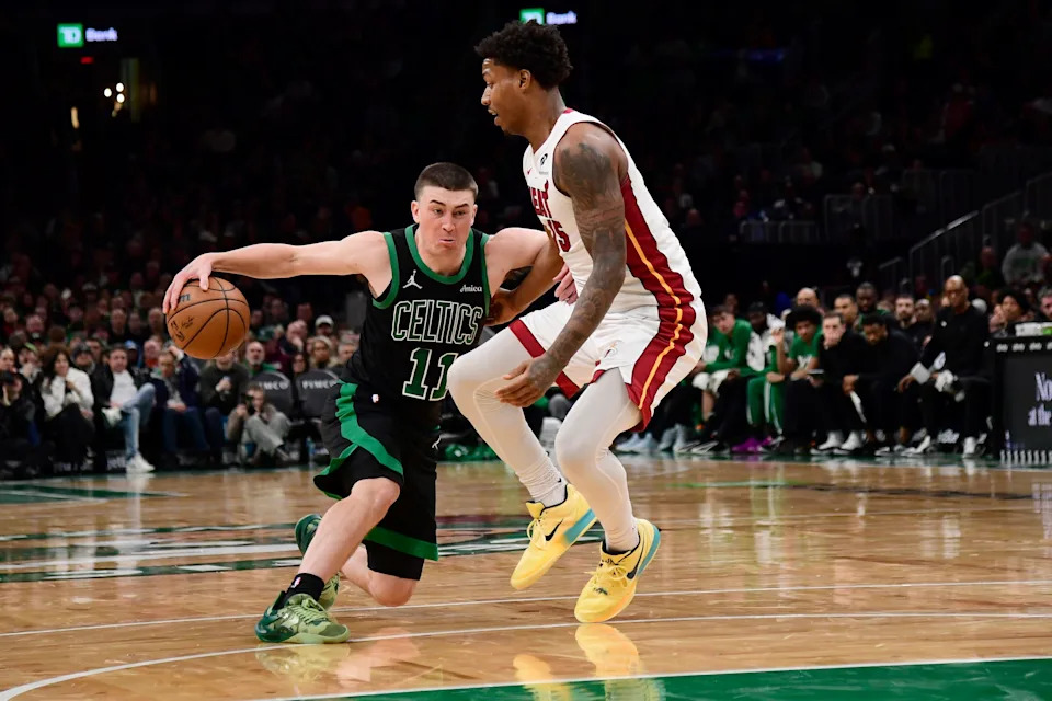 Feb 6, 2026; Boston, Massachusetts, USA; Boston Celtics guard Payton Pritchard (11) controls the ball while Miami Heat guard Davion Mitchell (45) defends during the second half at TD Garden. Mandatory Credit: Bob DeChiara-Imagn Images