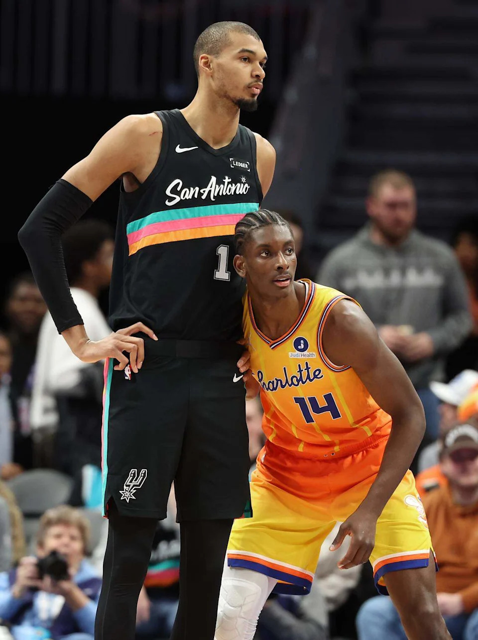 Charlotte Hornets forward/center Moussa Diabate, right, lines up next to San Antonio Spurs center Victor Wembanyama on Saturday. Despite the obvious height difference, Diabate outrebounded Wembanyama, 10-8.