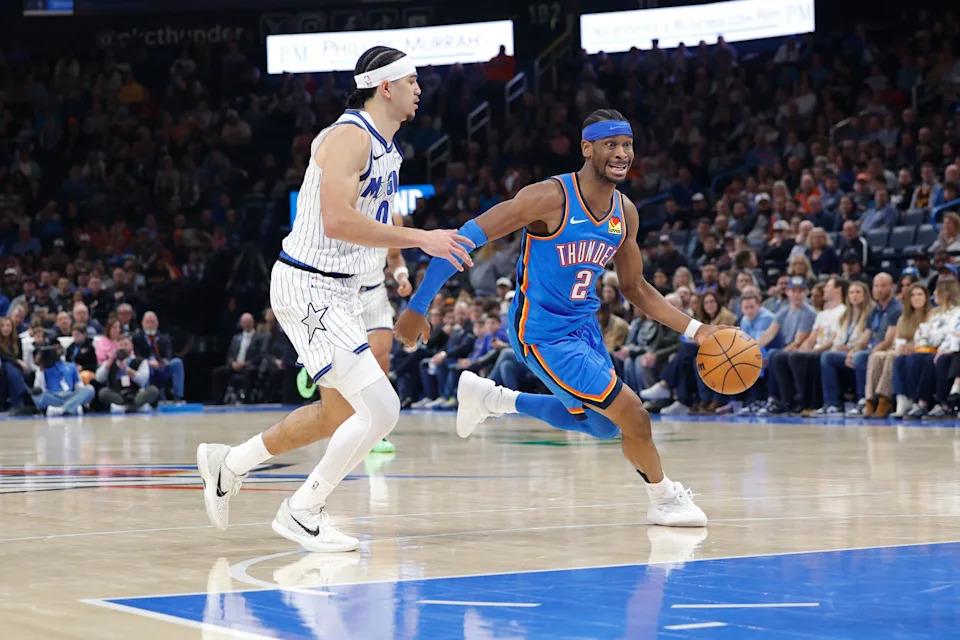 Feb 3, 2026; Oklahoma City, Oklahoma, USA; Oklahoma City Thunder guard Shai Gilgeous-Alexander (2) drives around Orlando Magic forward Jamal Cain (8) during the second half at Paycom Center. Mandatory Credit: Alonzo Adams-Imagn Images