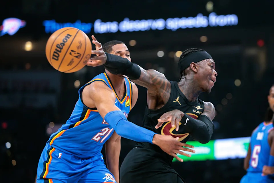 OKLAHOMA CITY, OKLAHOMA - FEBRUARY 22: Dennis Schroder #8 of the Cleveland Cavaliers passes the ball around Aaron Wiggins #21 of the Oklahoma City Thunder during the first half at Paycom Center on February 22, 2026 in Oklahoma City, Oklahoma. NOTE TO USER: User expressly acknowledges and agrees that, by downloading and or using this photograph, User is consenting to the terms and conditions of the Getty Images License Agreement. (Photo by William Purnell/Getty Images)