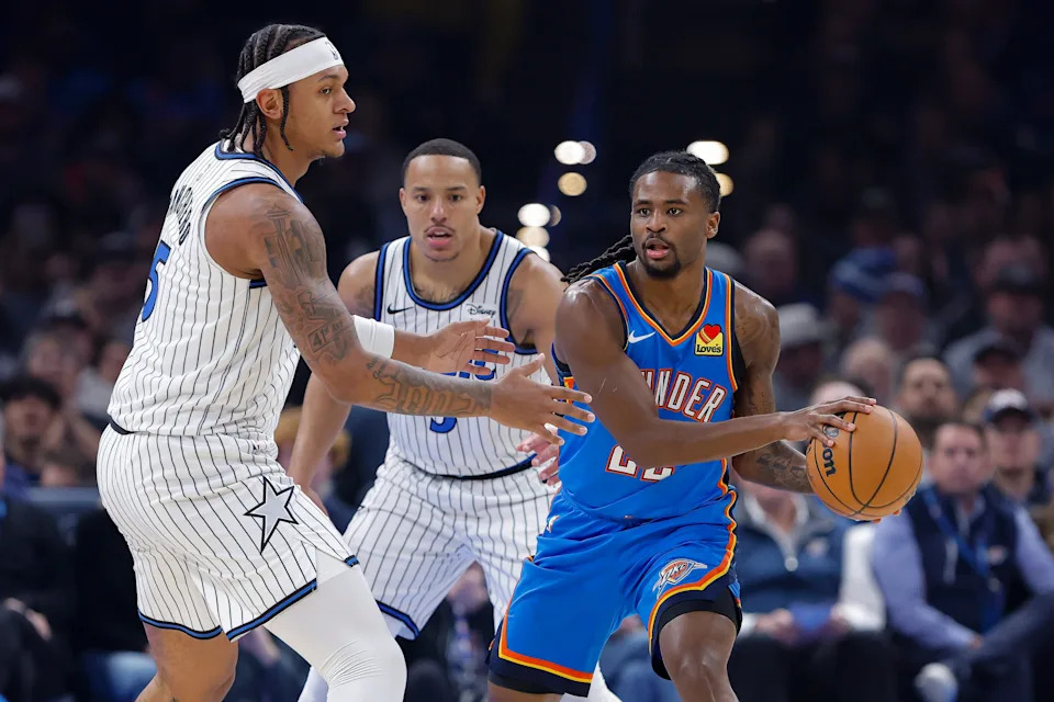 Feb 3, 2026; Oklahoma City, Oklahoma, USA; Oklahoma City Thunder guard Cason Wallace (22) moves the ball around Orlando Magic forward Paolo Banchero (5) during the first quarter at Paycom Center. Mandatory Credit: Alonzo Adams-Imagn Images