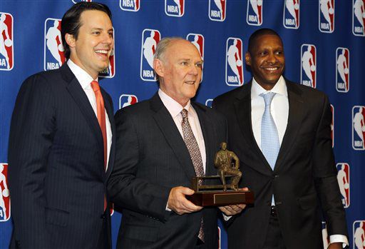 Denver  coach George Karl, center, holds up the Red Auerbach trophy for NBA Coach of the Year on May 8, 2013. Joining Karl are team president, Josh Kroenke, left, and general manager Masai Ujiri.