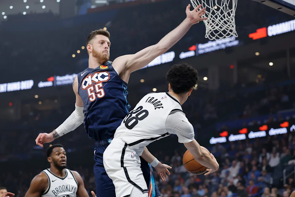 Feb 20, 2026; Oklahoma City, Oklahoma, USA; Brooklyn Nets guard Nolan Traore (88) passes around Oklahoma City Thunder center/forward Isaiah Hartenstein (55) during the first quarter at Paycom Center. Mandatory Credit: Alonzo Adams-Imagn Images