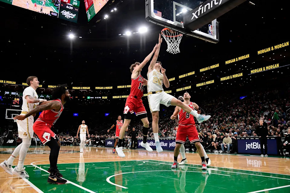 Jan 5, 2026; Boston, Massachusetts, USA; Chicago Bulls forward Matas Buzelis (14) fouls Boston Celtics guard Hugo Gonzalez (28) during the first half at TD Garden. Mandatory Credit: Bob DeChiara-Imagn Images