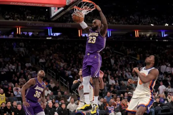 Los Angeles Lakers forward LeBron James (23) dunks against New York Knicks guard Josh Hart (3) and forward OG Anunoby (8) during the third quarter at Madison Square Garden on Feb 1, 2026.