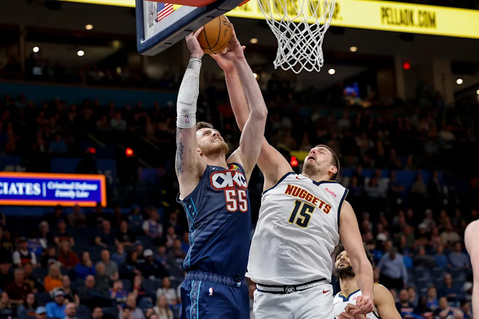 Feb 27, 2026; Oklahoma City, Oklahoma, USA; Oklahoma City Thunder center/forward Isaiah Hartenstein (55) goes up for a basket beside Denver Nuggets center Nikola Jokić (15) during the third quarter at Paycom Center. Mandatory Credit: Alonzo Adams-Imagn Images