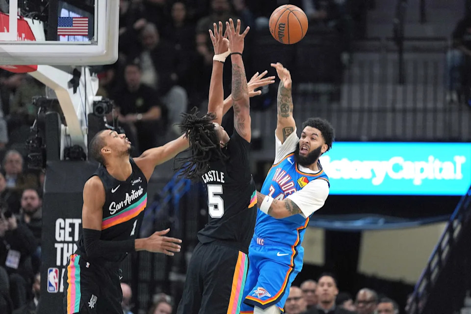 Feb 4, 2026; San Antonio, Texas, USA; Oklahoma City Thunder forward Kenrich Williams (34) passes the ball over San Antonio Spurs forward Victor Wembanyama (1) and guard Stephon Castle (5) during the first half at Frost Bank Center. Mandatory Credit: Scott Wachter-Imagn Images