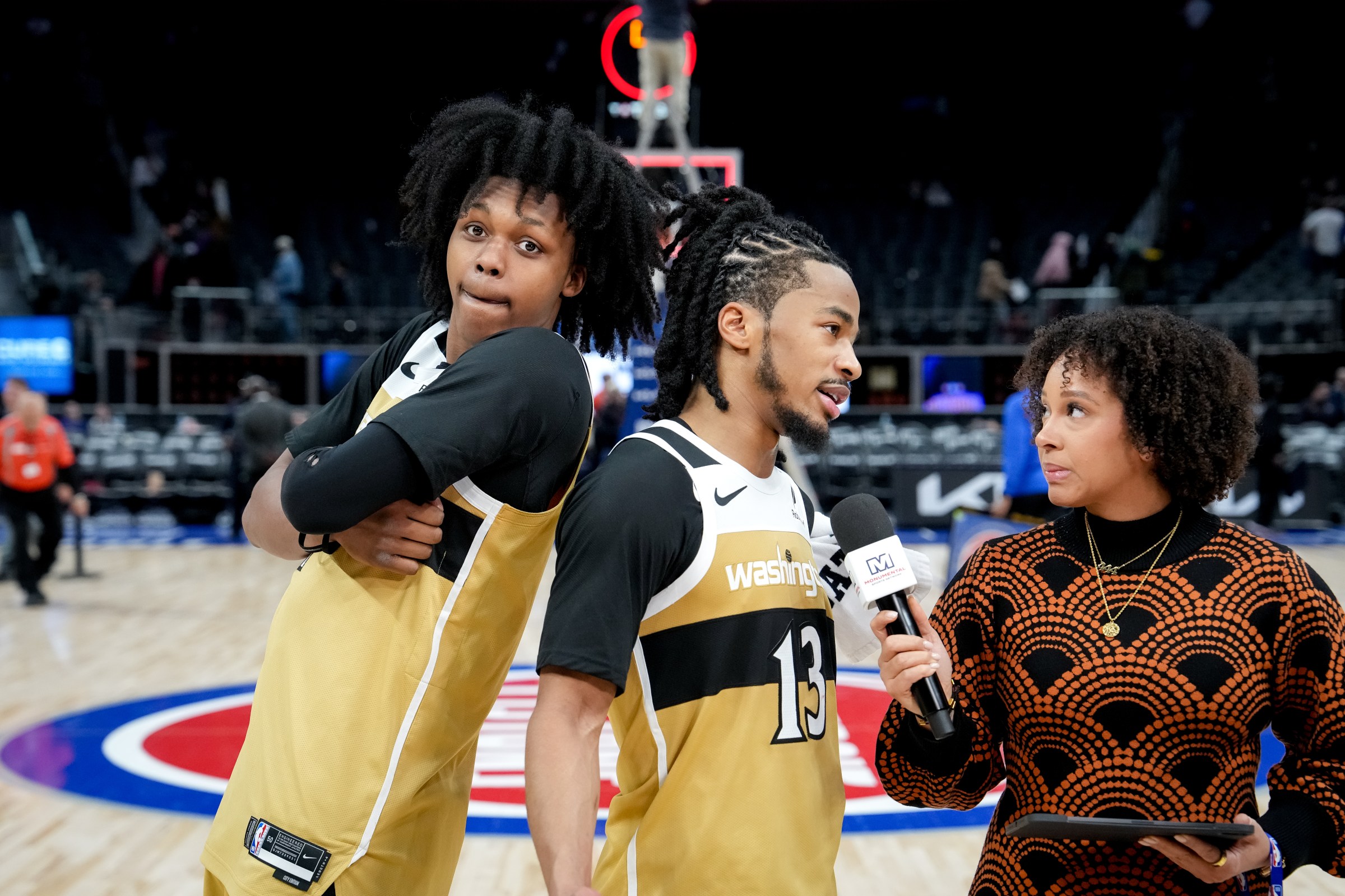 DETROIT, MICHIGAN - FEBRUARY 05: Bub Carrington #7 of the Washington Wizards jokes around with Sharife Cooper #13 of the Washington Wizards as Cooper is interviewed after the win against the Detroit Pistons at Little Caesars Arena on February 05, 2026 in Detroit, Michigan. NOTE TO USER: User expressly acknowledges and agrees that, by downloading and or using this photograph, User is consenting to the terms and conditions of the Getty Images License Agreement. (Photo by Nic Antaya/Getty Images)