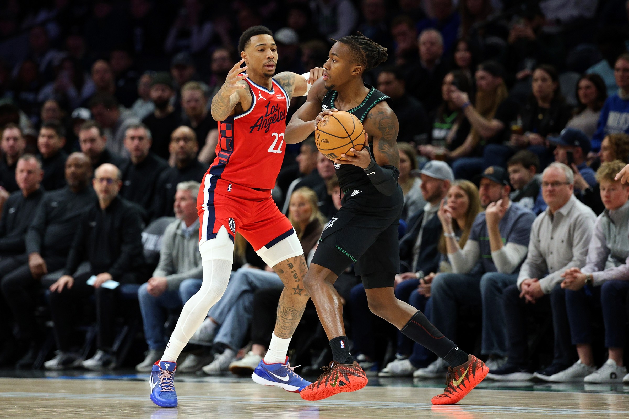 MINNEAPOLIS, MINNESOTA - FEBRUARY 08: Ayo Dosunmu #13 of the Minnesota Timberwolves handles the ball against Jordan Miller #22 of the Los Angeles Clippers in the first quarter at Target Center on February 08, 2026 in Minneapolis, Minnesota. NOTE TO USER: User expressly acknowledges and agrees that, by downloading and or using this photograph, User is consenting to the terms and conditions of the Getty Images License Agreement. (Photo by David Berding/Getty Images)