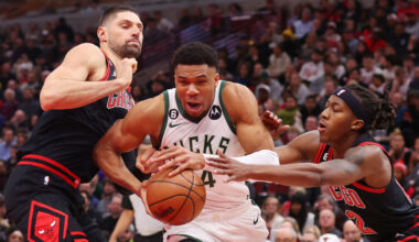 Giannis Antetokounmpo #34 of the Milwaukee Bucks drives to the basket against Nikola Vucevic #9 and...