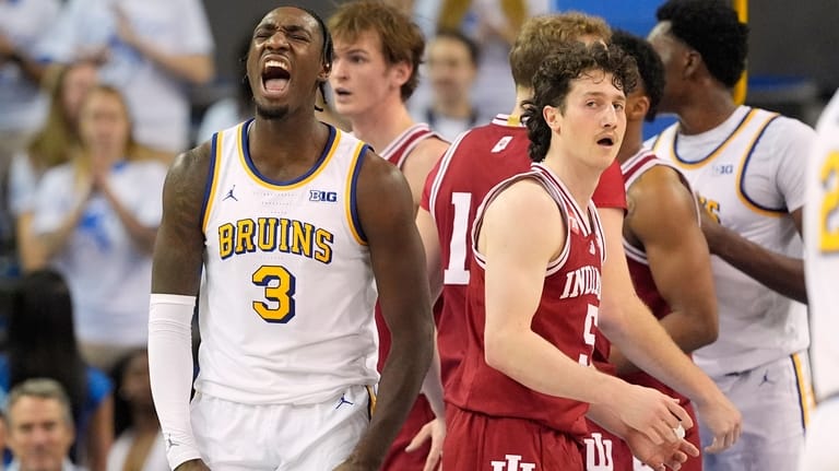 UCLA guard Eric Dailey Jr., left, celebrates after scoring as...