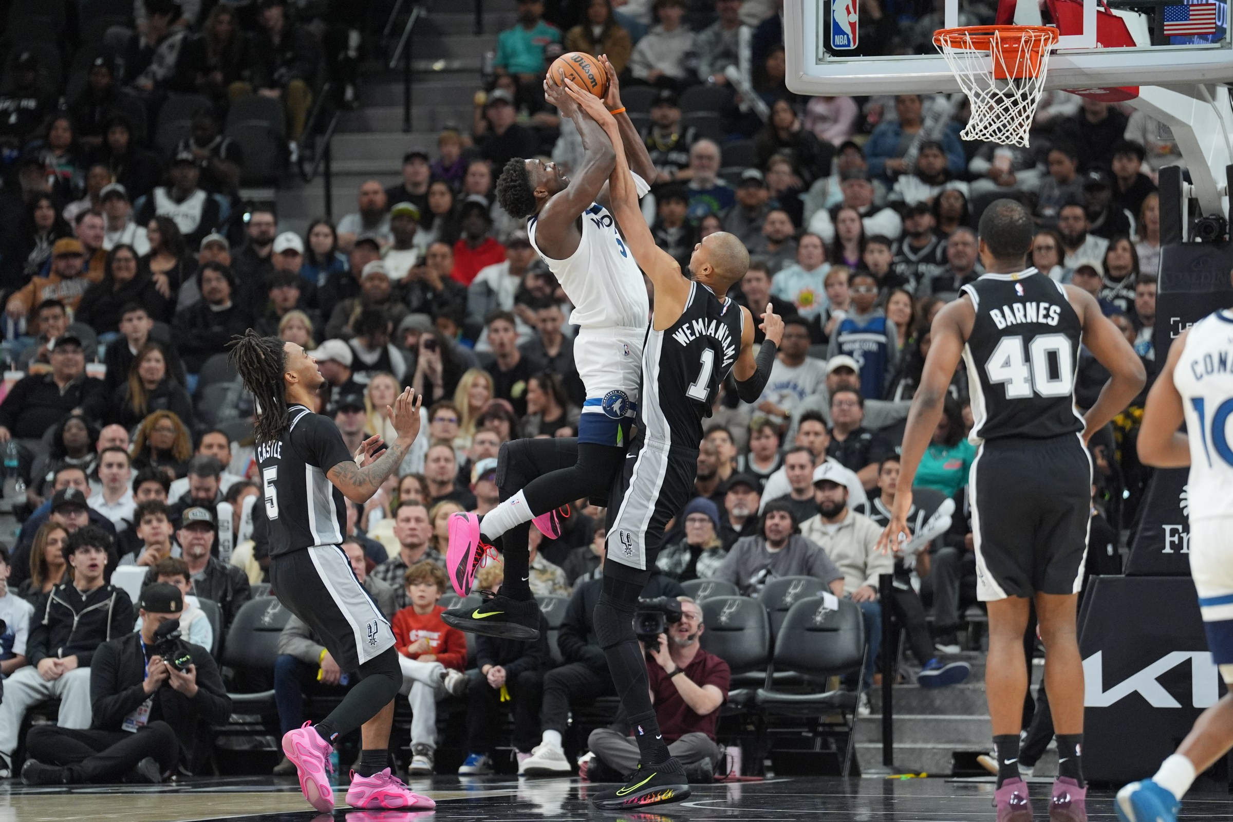 Jan 17, 2026; San Antonio, Texas, USA; San Antonio Spurs forward Victor Wembanyama (1) fouls Minnesota Timberwolves guard Anthony Edwards (5) in the second half at Frost Bank Center. Mandatory Credit: Daniel Dunn-Imagn Images
