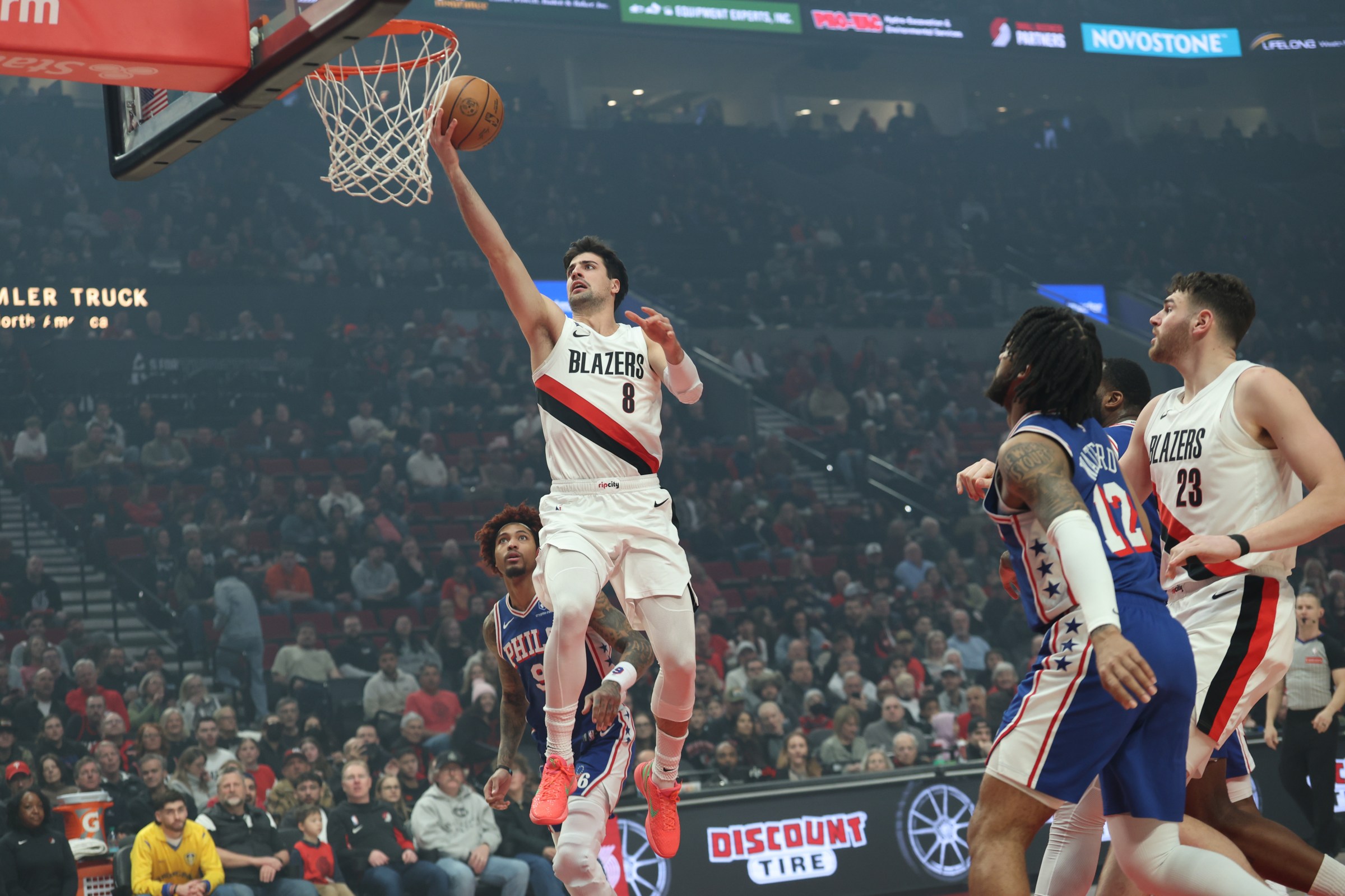 Feb 9, 2026; Portland, Oregon, USA; Portland Trail Blazers forward Deni Avdija (8) shoots the ball over Philadelphia 76ers forward/guard Kelly Oubre Jr. (9) during the first half at Moda Center. Mandatory Credit: Jaime Valdez-Imagn Images