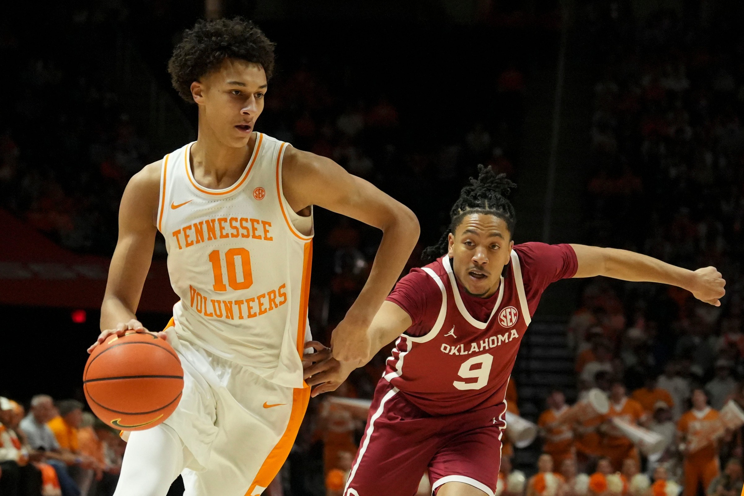 Tennessee forward Nate Ament (10) moves the ball while guarded by Oklahoma guard Nijel Pack (9) during an NCAA college basketball game on Feb. 18, 2026, in Knoxville, Tennessee.