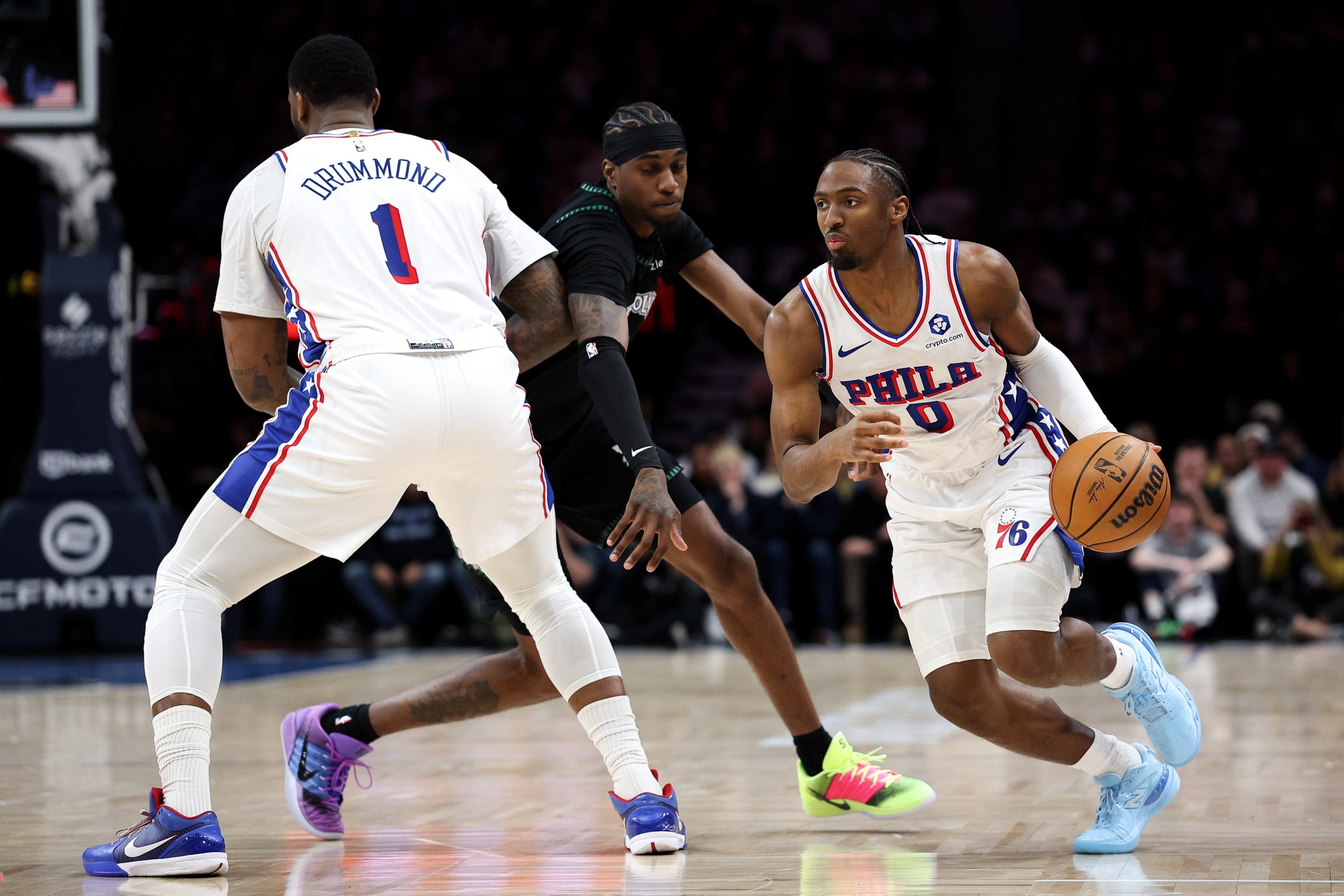 Feb 22, 2026; Minneapolis, Minnesota, USA; Philadelphia 76ers guard Tyrese Maxey (0) works around Minnesota Timberwolves forward Jaden McDaniels (3) during the first half at Target Center. Mandatory Credit: Matt Krohn-Imagn Images