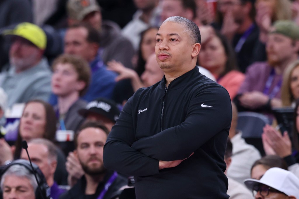 LA Clippers head coach Tyronn Lue looking on.