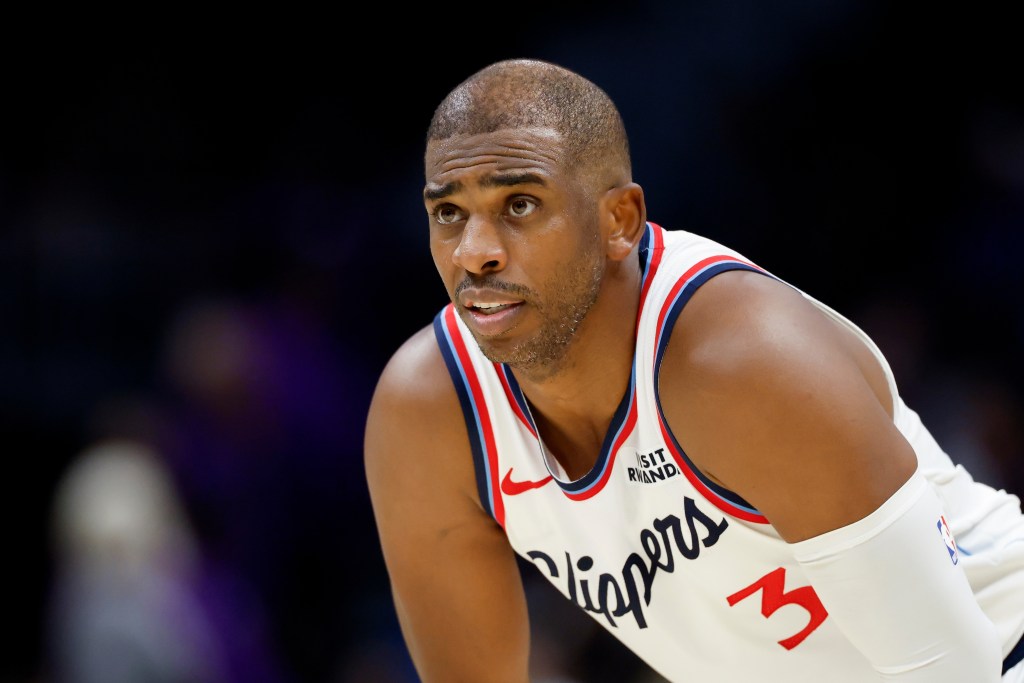 Chris Paul wearing a white Clippers jersey.